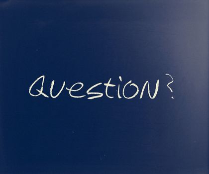 "Question" handwritten with white chalk on a blackboard.