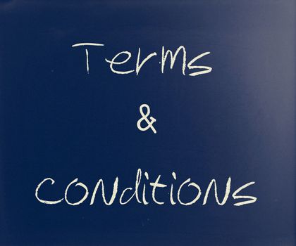 "Terms & Conditions" handwritten with white chalk on a blackboard.