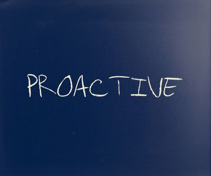 The word 'Proactive' handwritten with white chalk on a blackboard.