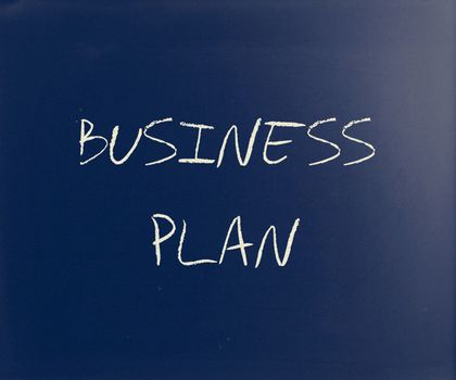 "Business plan" handwritten with white chalk on a blackboard.