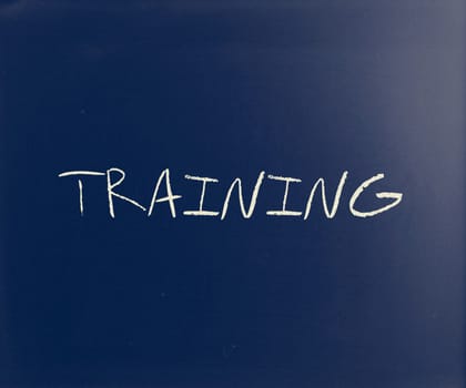"Training" handwritten with white chalk on a blackboard.