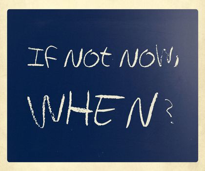 "If not now, when?" handwritten with white chalk on a blackboard.