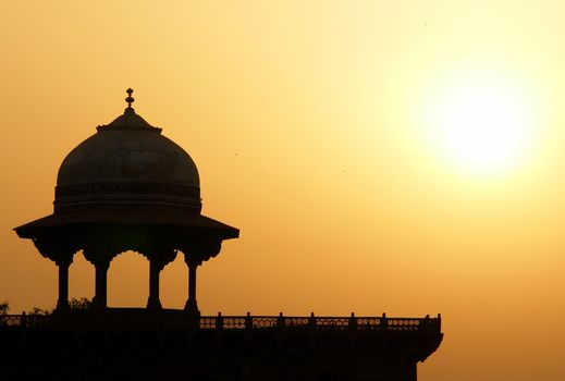 Moslem fortress silhouette at sunrise. Taj Mahal, Agra, India
