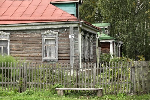 View of the old a log house with with garden