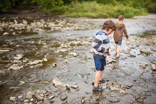 Two children playing in a river