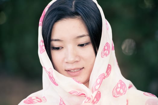 Detailed portrait of beautiful young woman with skull covering head