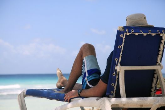 Man has a rest in an armchair