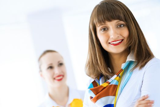 Portrait of a young successful business woman standing against colleagues