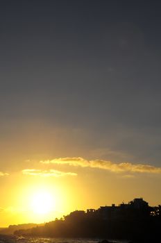 Silhouettes of Houses at Sunset over a Sea Village