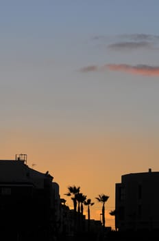 Silhouettes of Houses at Sunset over a Sea Village