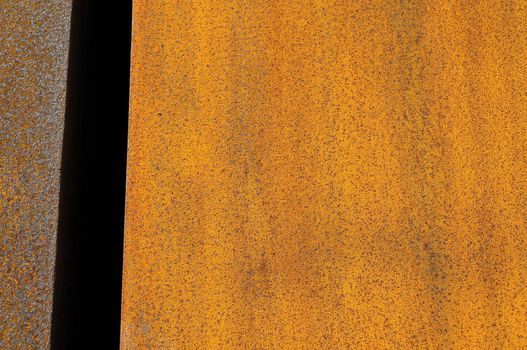 Orange Patterns on the Rusty Surface of the Metal