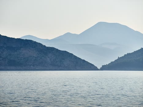 Coast between two islands in morning mist        