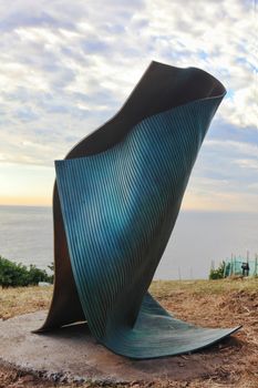 Bondi, Australia - November 3,  2013: Sculpture By The Sea, Bondi 2013. Annual cultural event that showcases artists from around the world  Sculpture titled 'folded 3 (2012)' by Andrew Rogers (VIC).  Medium - bronze.  Price $92500