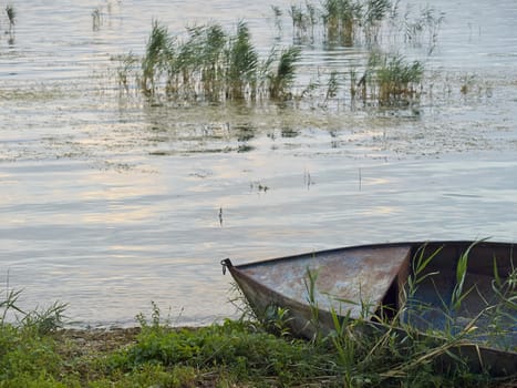 abandoned boat on shore of a Lake       