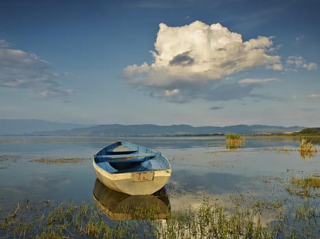 Boat on sunset in the lake    