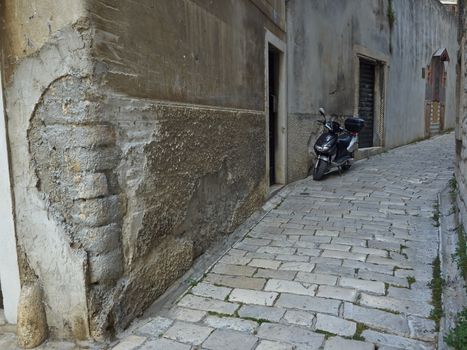 Scuter in in narrow street of Sibenik, Croacia    