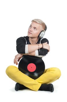 Man with vinyl record sitting on the floor