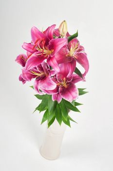 Studio shoot of purple lily bouquet in vase