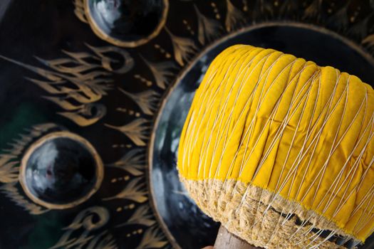 Hand hit big gong in temple