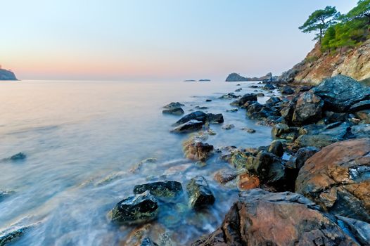 steep cliffs with a calm sea and pine