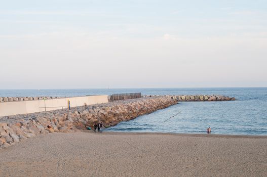 Sea landscape with sandy beach and pier