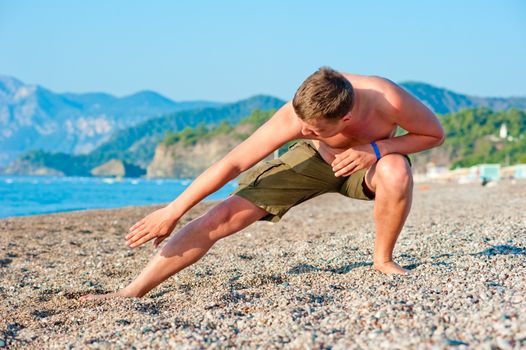 man playing sports on the beach at dawn