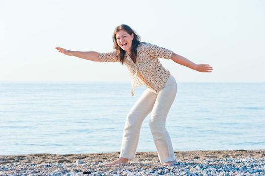 young girl on the beach fooling around