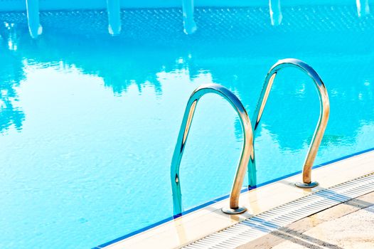 steps leading to the pool and reflection in water