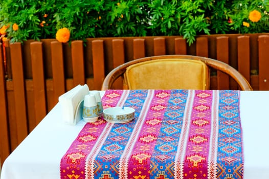 a table covered with a cloth with oriental patterns