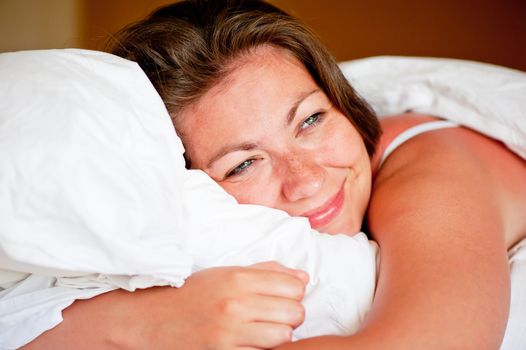 pretty girl in bed with a pillow