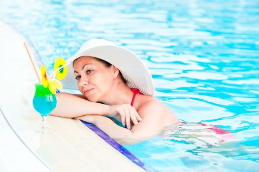 Woman in bikini and hat in the pool