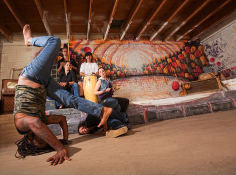 Acrobatic group of capoeira performers in building