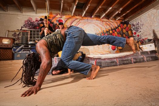 Pair of male capoeira artists tumbling and kicking