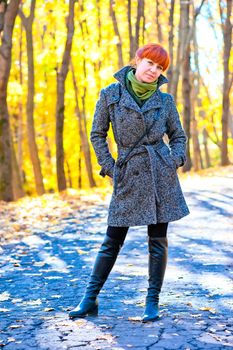 girl in autumn park for a walk on a sunny day