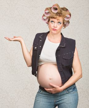Indifferent pregnant single female in curlers with hand up