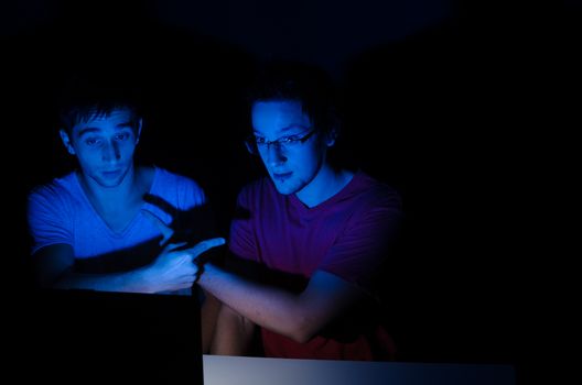 Two friends chatting on a laptop with webcam