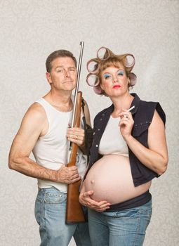 Negligent pregnant hillbilly couple with rifle and cigarettes