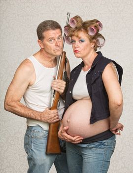 Concerned pregnant hillbilly couple with rifle gun