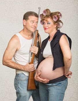 Hillbilly with rifle and adoring pregnant wife