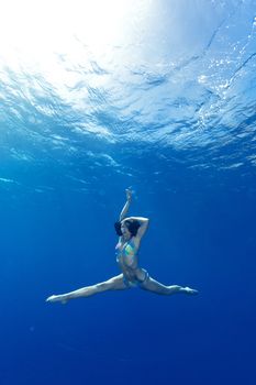 athletic girl making yoga in the sea