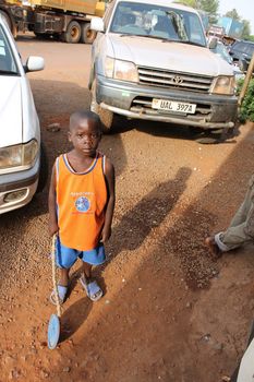 Uganda - 4 March: the Ugandan boy stands on the background of the car and looks at the photographer 4 March 2012 in Uganda.