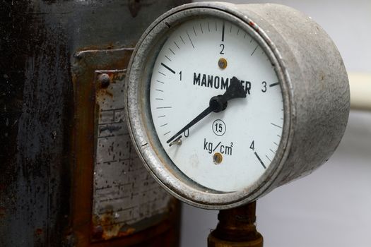 Manometer on an old rusty gas tank