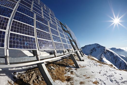 Big cluster of solar panels on a mountain peak