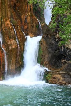 water falling to river between huge rocks 