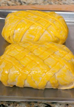 Beef Wellington  ready to be baked with egg yolk on them