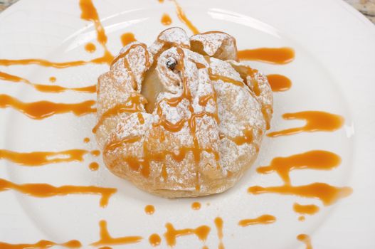Poached pear dessert filled with pecans, blue cheese and caramel sauce
