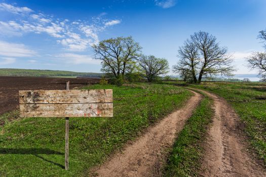 old wooden sign on a country road in rural areas