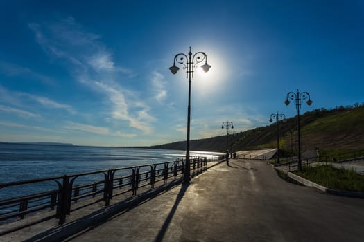 Street lights on the promenade on the shore of the great river