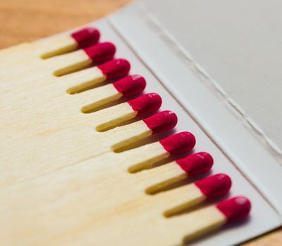 Set of red matches close up on white background