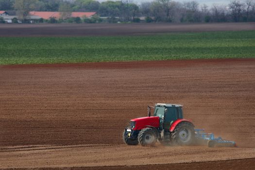 Tractor plowing the agicultural fields